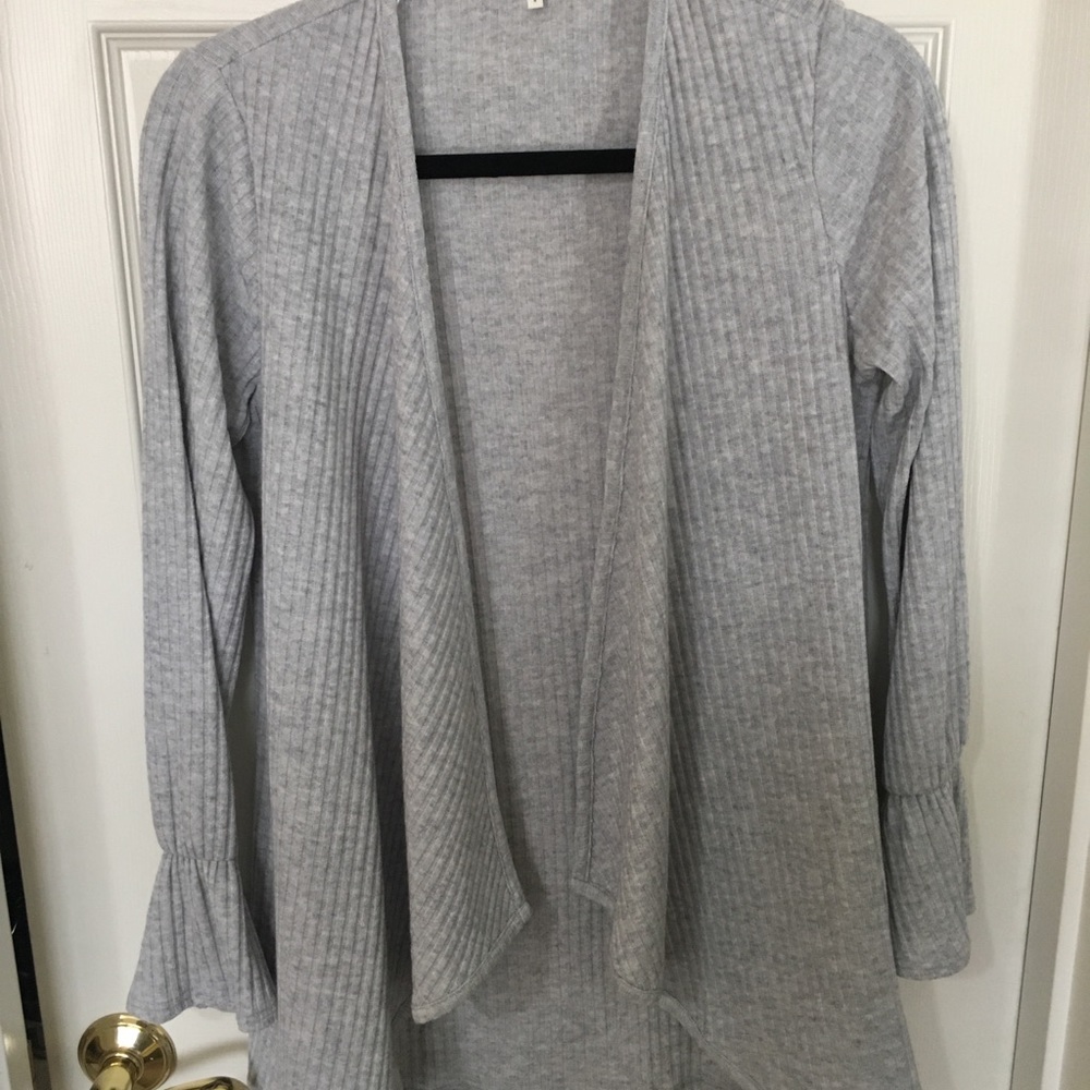 Gray sweater with bell sleeve detail.